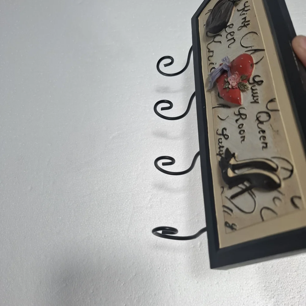 Wall Hook Rack with Black Frame and Red Hat Accent